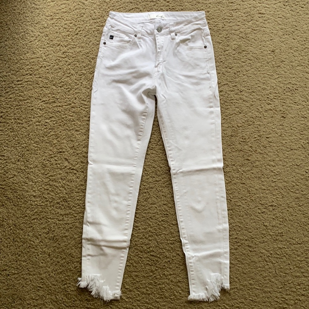 Skinny white jeans with distressed bottoms